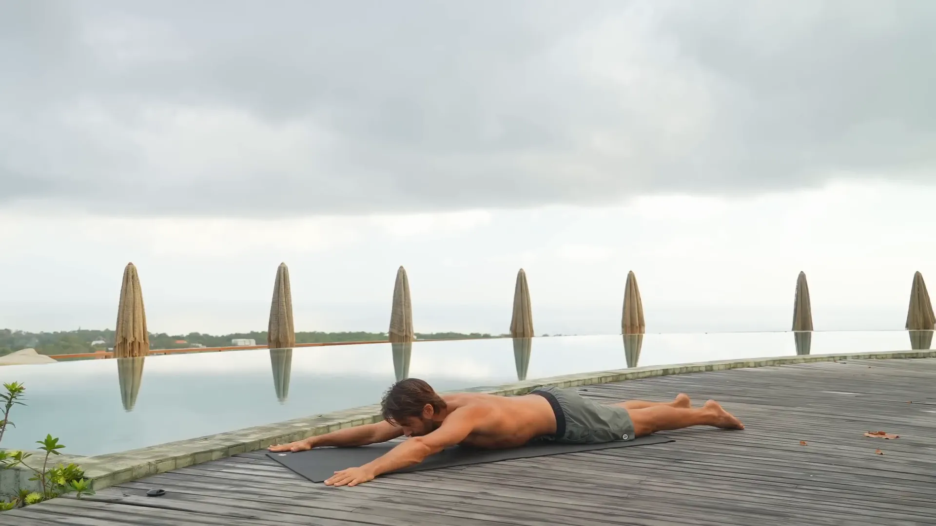 Prone position with arms reaching wide and elbows pulling back