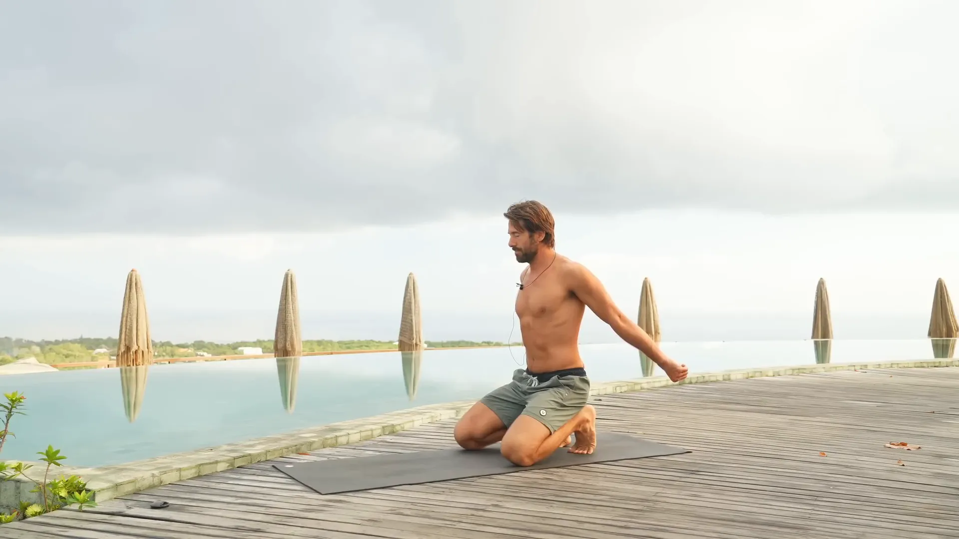 Hands on lower back with elbow reach and shoulder rotation