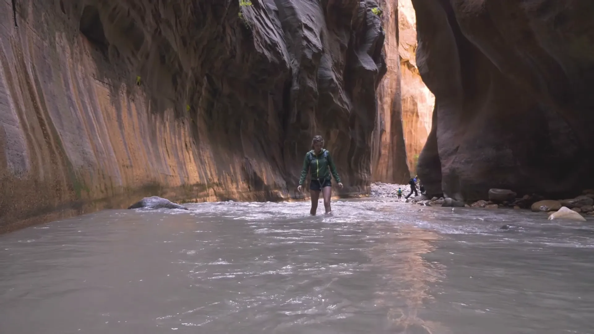 Hikers wading through the Narrows in Zion National Park