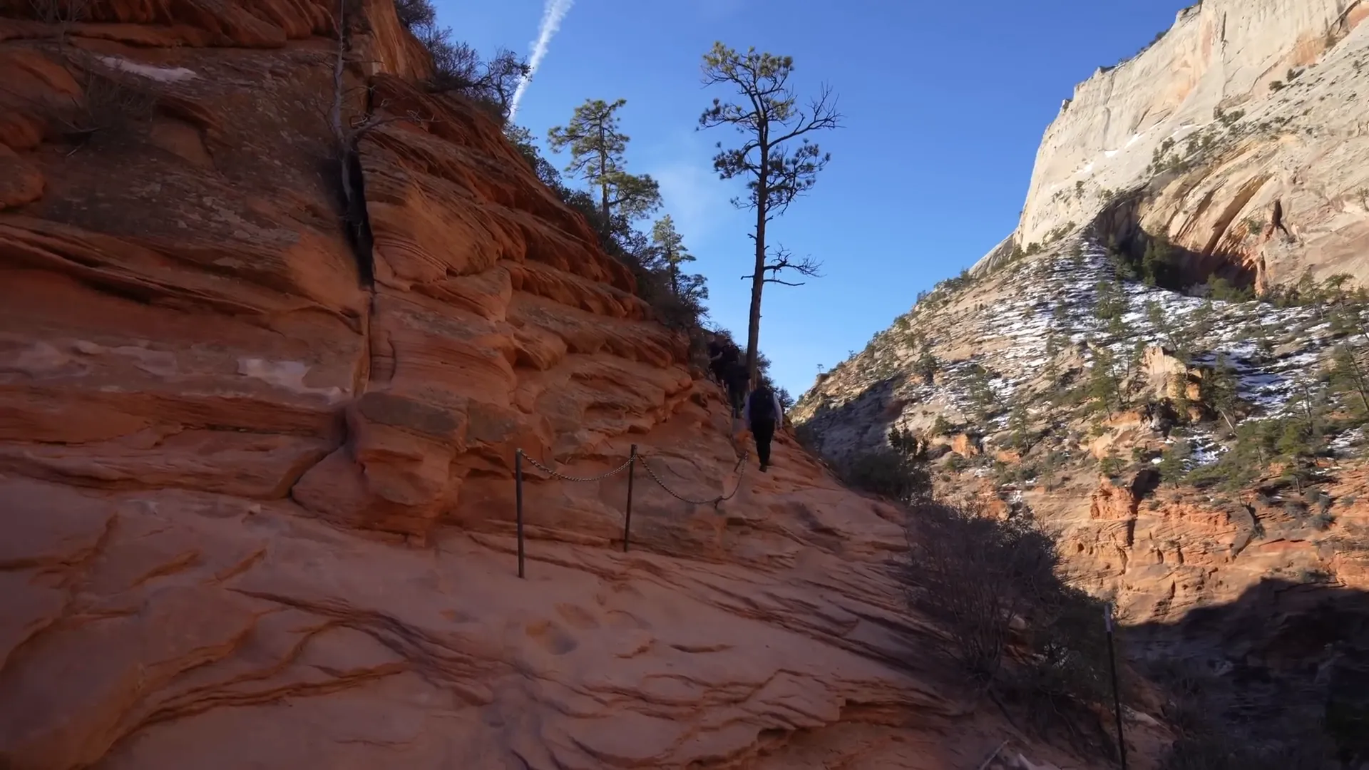 Hiker using chains on the narrow path