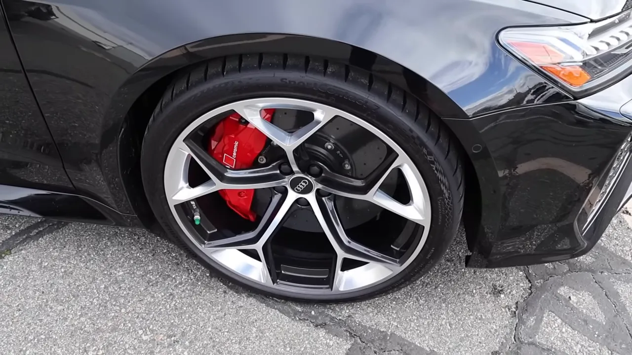 Close-up of Audi RS7 wheel showing 22-inch rim, 285/30 tire and red ceramic brake caliper