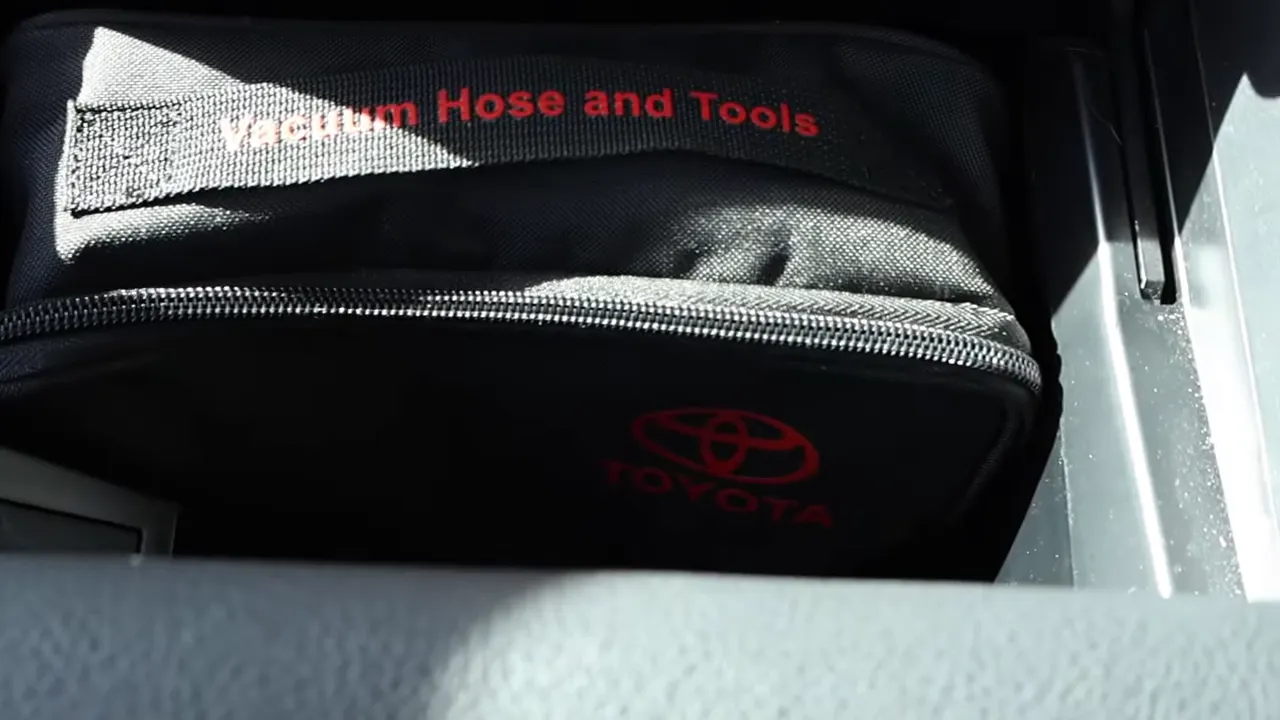 Toyota-branded vacuum hose and tools kit tucked inside the Sienna center console