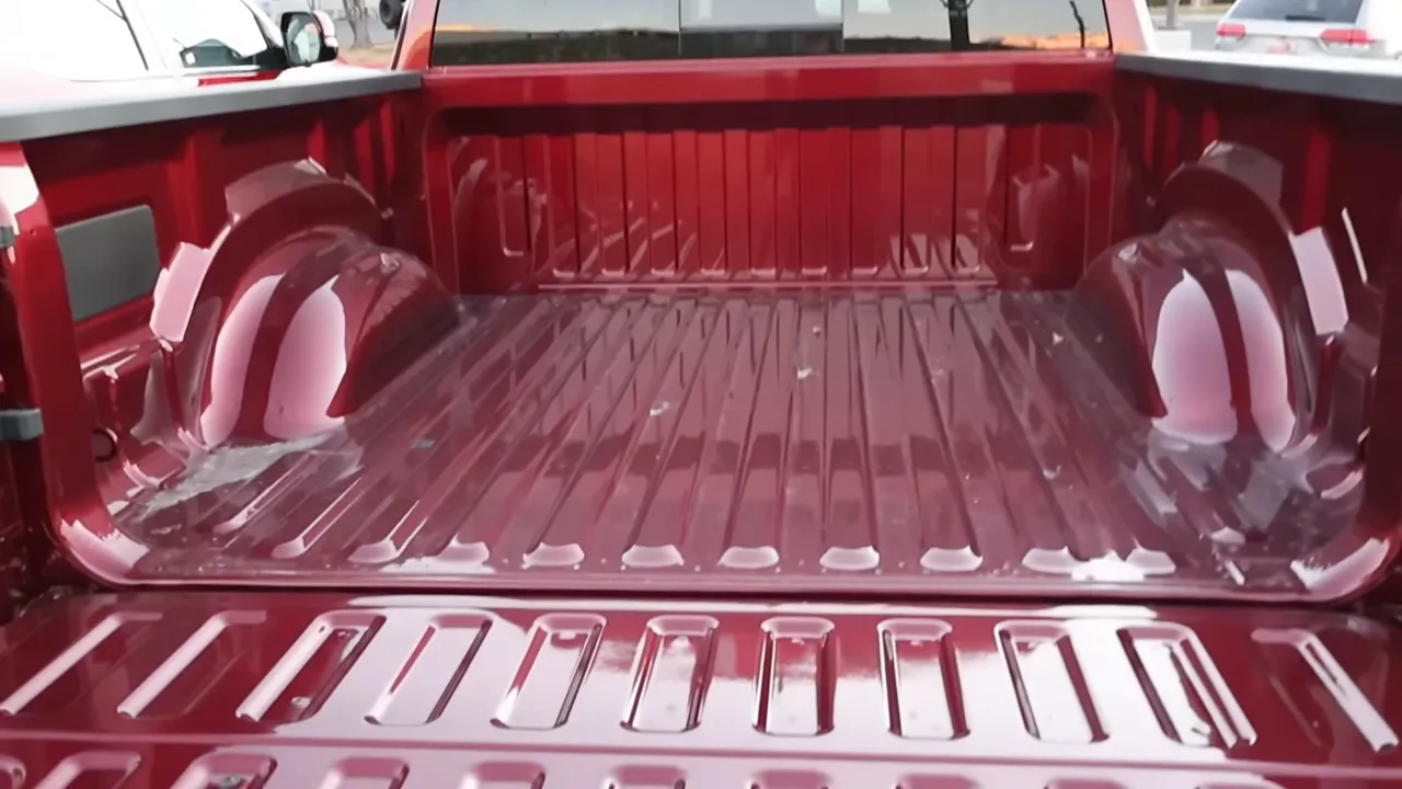 Truck composite bed interior with painted floor, wheel wells and tie-down points