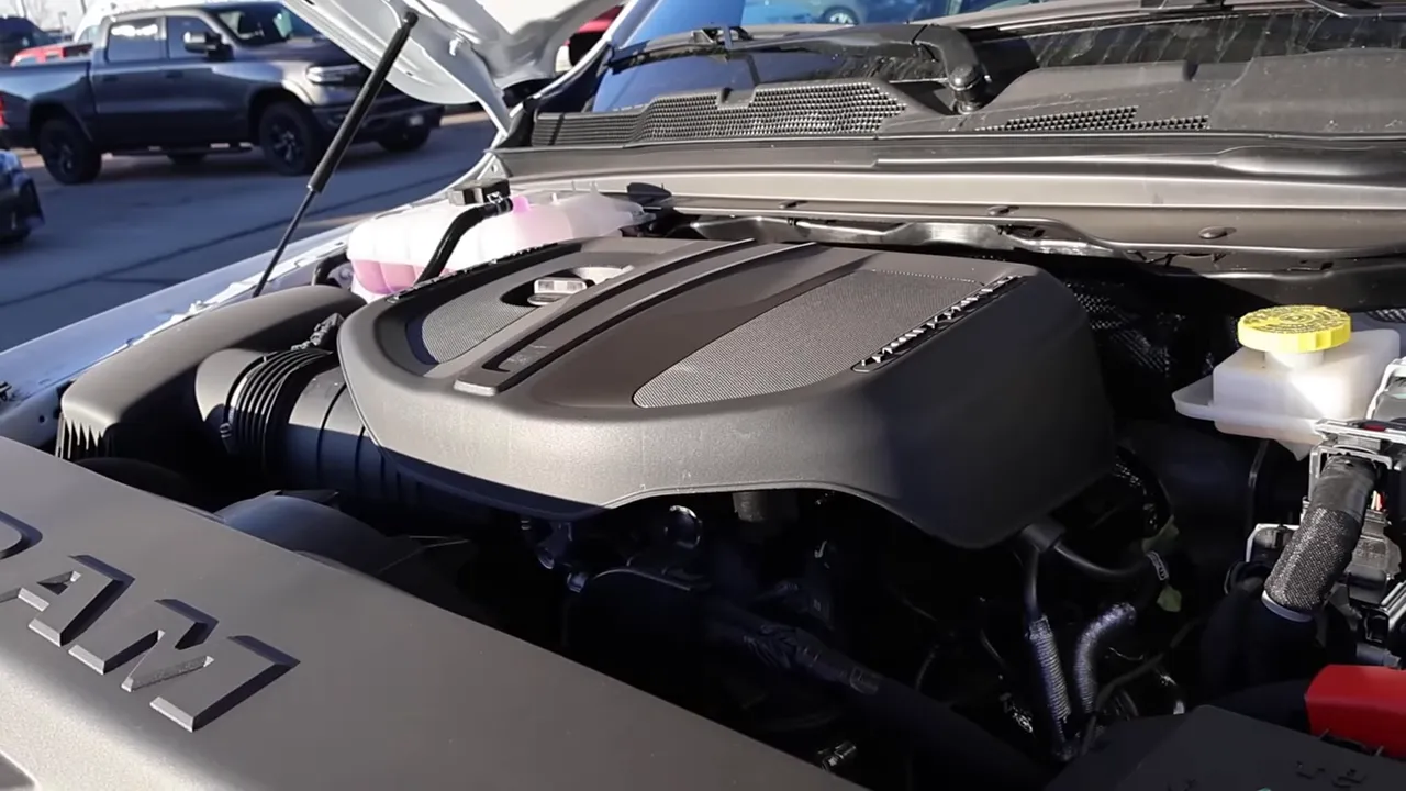 well-lit ram 3.0 hurricane engine cover with coolant reservoir and intake visible