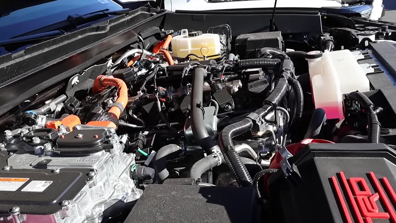 Tacoma hybrid engine bay with bright orange high-voltage cables and hybrid modules, clear and sharp