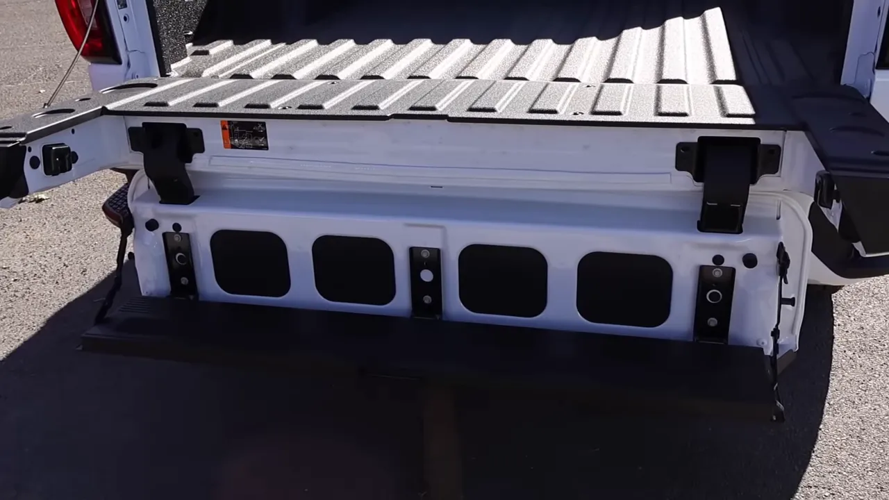 GMC Sierra tailgate inner panel showing the MultiPro step and bed access with spray-in liner