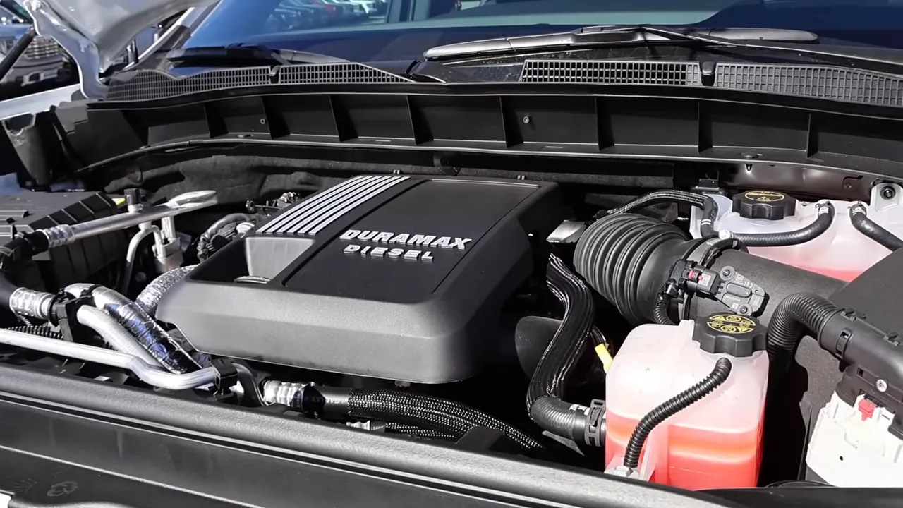 Top-side view of the 3.0L Duramax diesel engine cover and engine bay in a 2026 GMC Sierra AT4