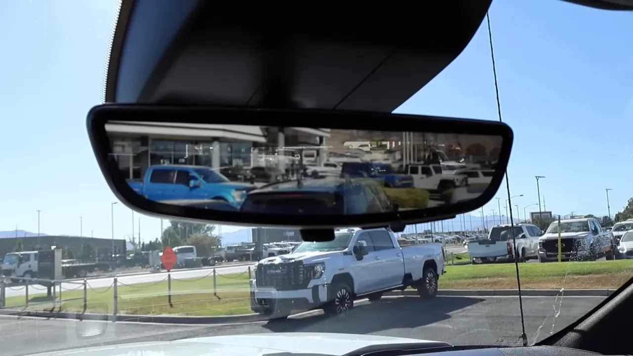 Camera rearview mirror showing a live camera feed and dealership lot behind the 2026 GMC Sierra AT4