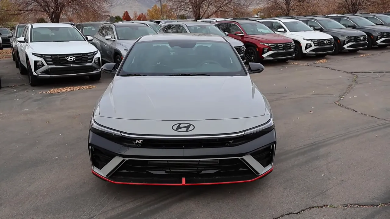 Front view of 2026 Hyundai Elantra N parked among other cars, showing grille and N badge