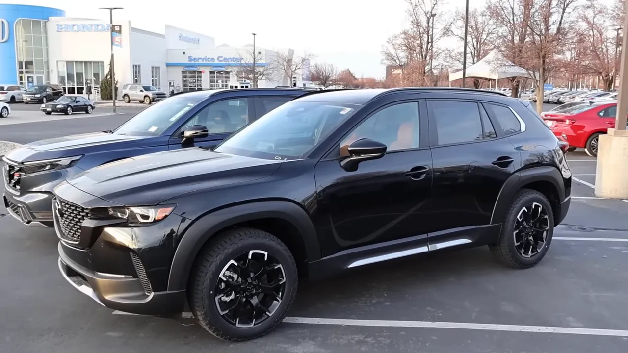 Mazda CX-50 Meridian side profile showing wide low stance and black all-terrain wheels