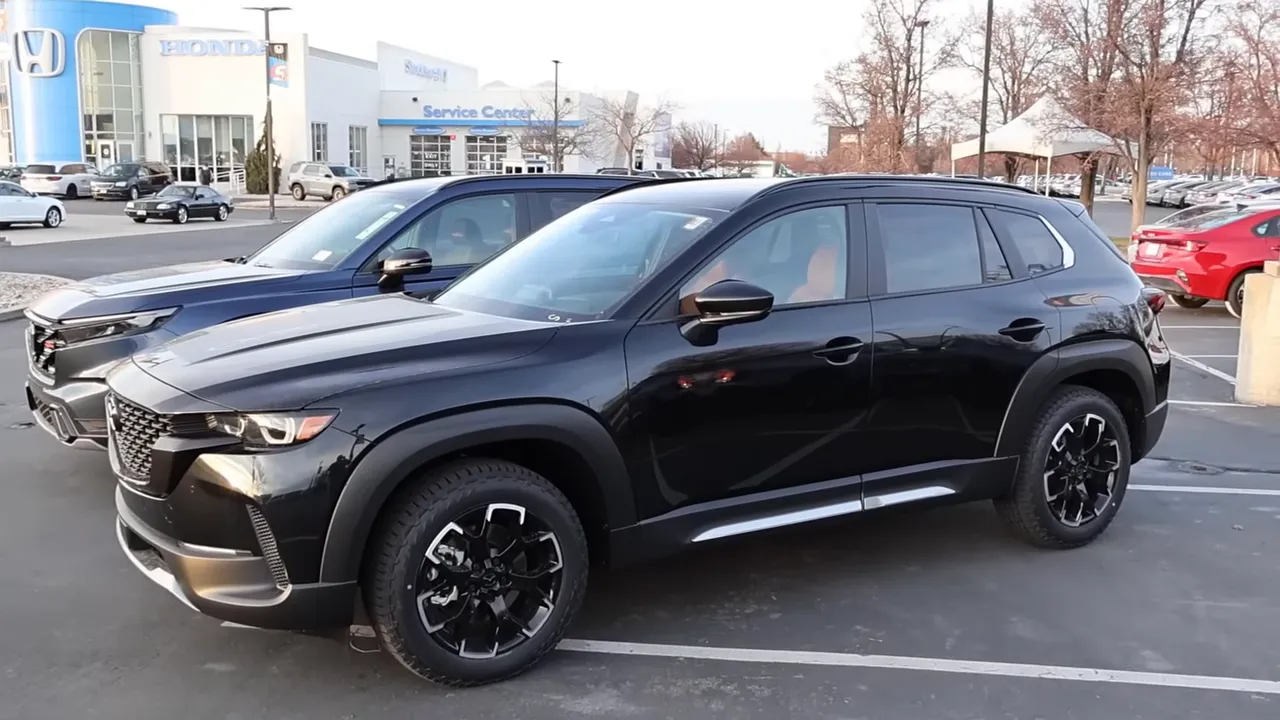 Side profile of Mazda CX-50 Meridian showing off-road cladding and black alloy wheels