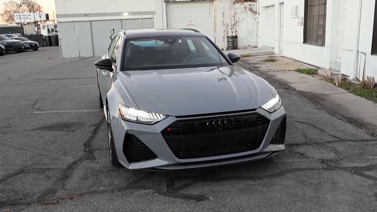 2026 Audi RS6 Avant front view in gray parked with headlights on