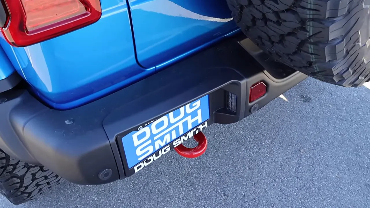 2026 Jeep Wrangler Rubicon X rear bumper with full-size spare tire and red recovery/tow hook
