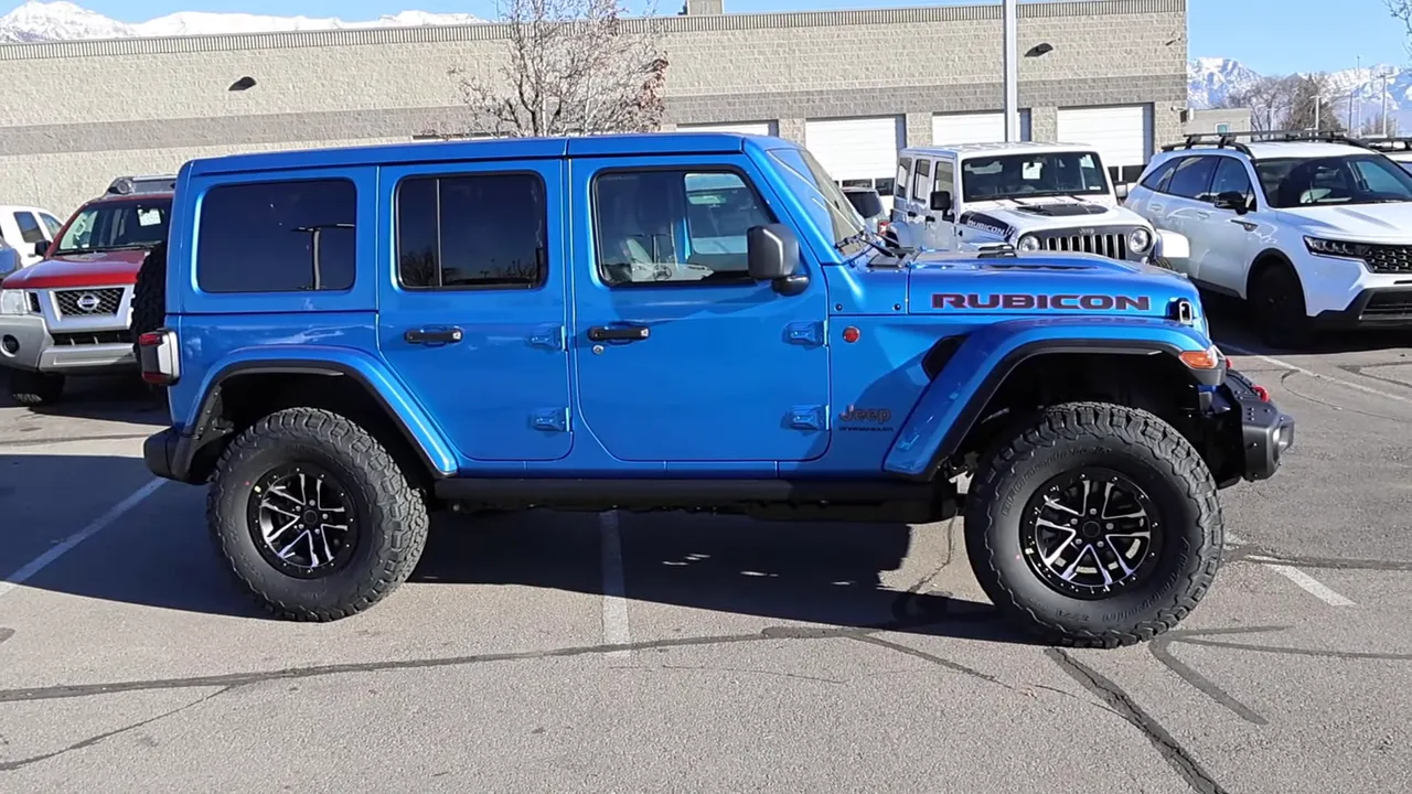 Side profile of 2026 Jeep Wrangler Rubicon X with factory lift and large off-road tires