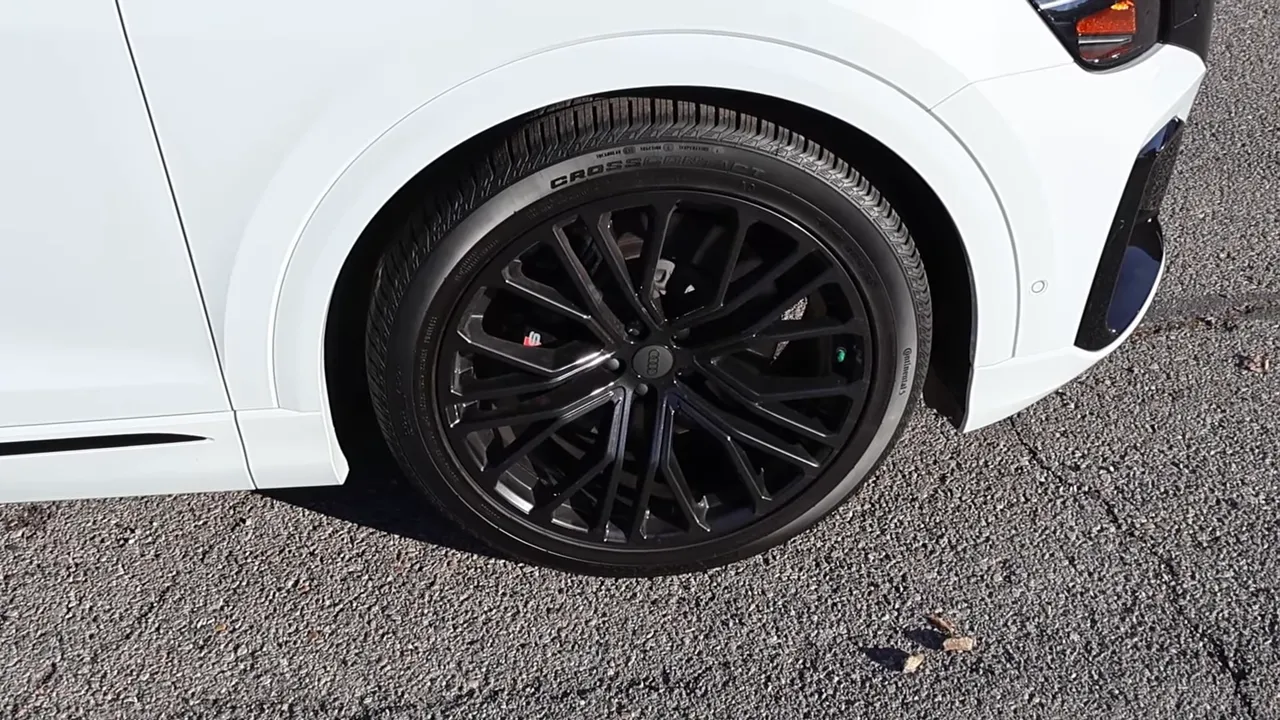 Close-up of Audi SQ8 black multi-spoke wheel and tire