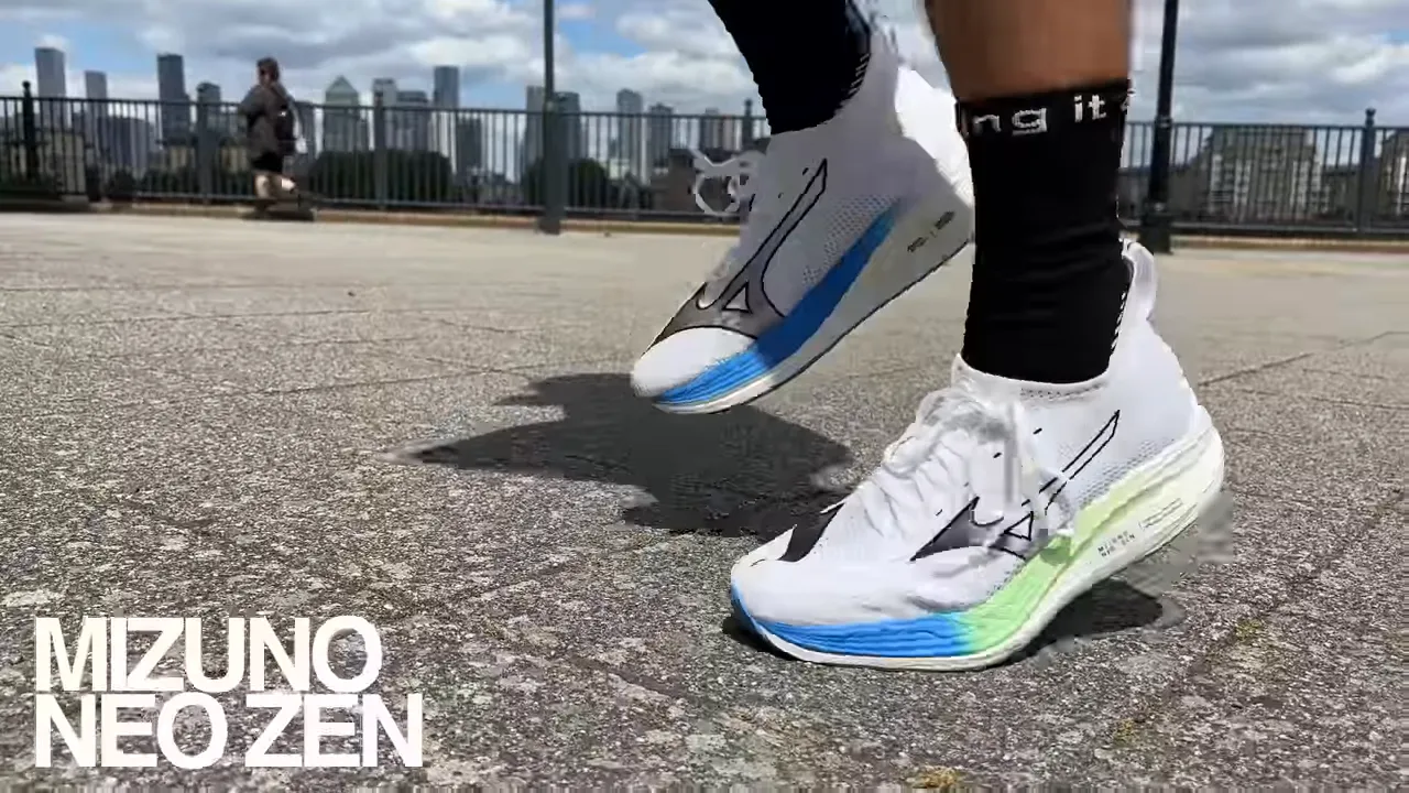 Close-up of Mizuno Neo Zen running shoes mid-stride on pavement showing the colorful midsole and logo.