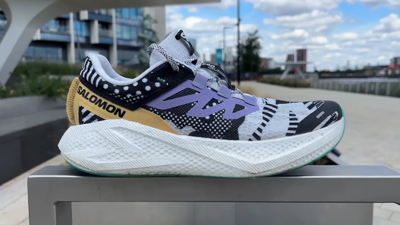 Salomon AeroGlide 3 side profile on a railing highlighting midsole texture and upper design