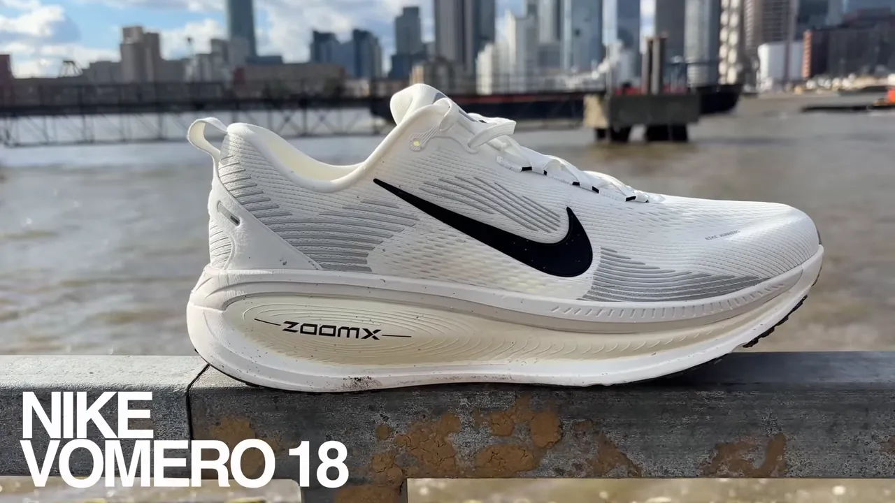 Nike Vomero 18 side profile shot on a railing with city skyline in background