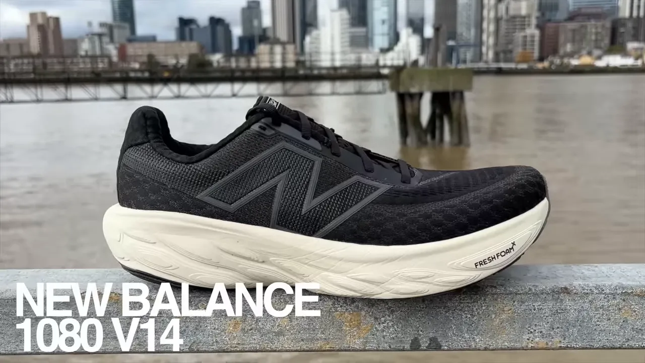 New Balance 1080 v14 black running shoe side profile on a railing with river and city skyline in the background