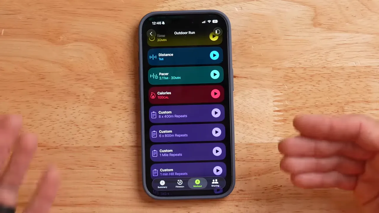 Phone displaying mirrored workout screen while watch tracks a run