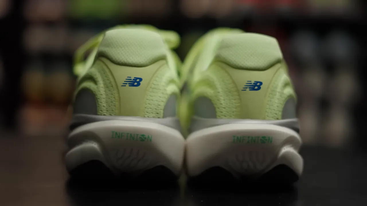 Rear close-up of New Balance 1080 v15 heels with visible 'INFINISH/INFINION' midsole branding