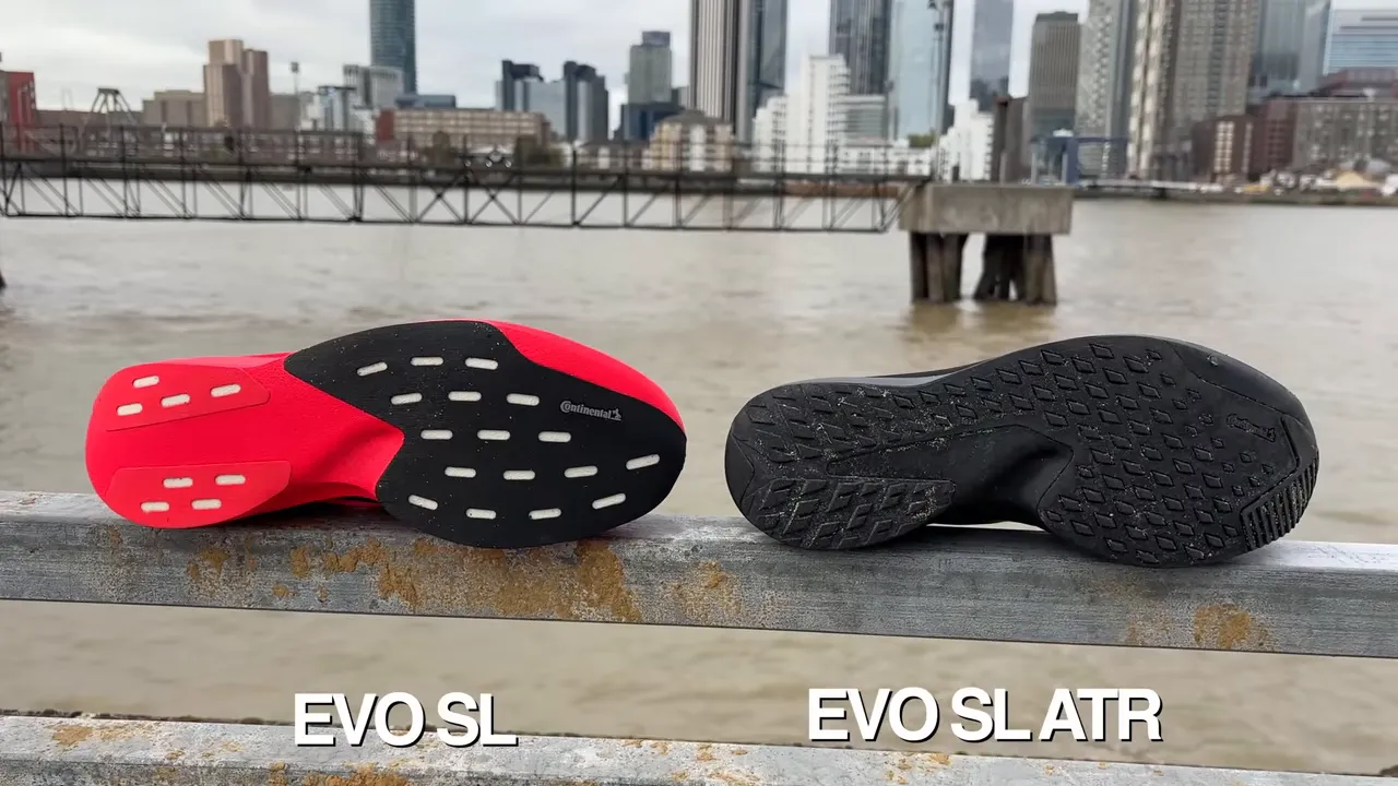 Two shoes laid sole-up on a railing: red midsole of the standard EVO SL on the left and the black, lugged EVO SL ATR outsole on the right for direct comparison.