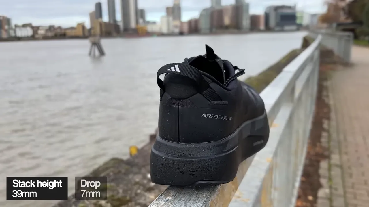 Rear angle of Adidas EVO SL ATR on a railing showing heel, mudguard and waterfront background with stack/drop overlay.
