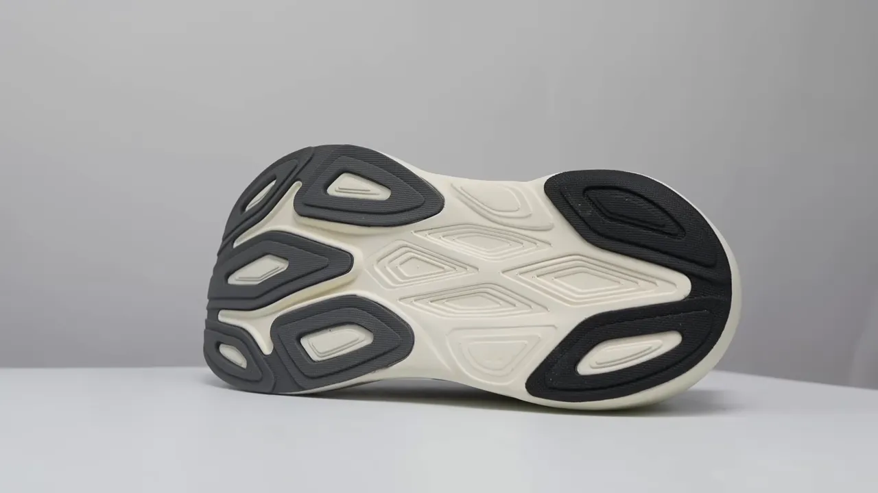 Flat studio view of New Balance More v6 outsole showing rubber coverage and exposed foam