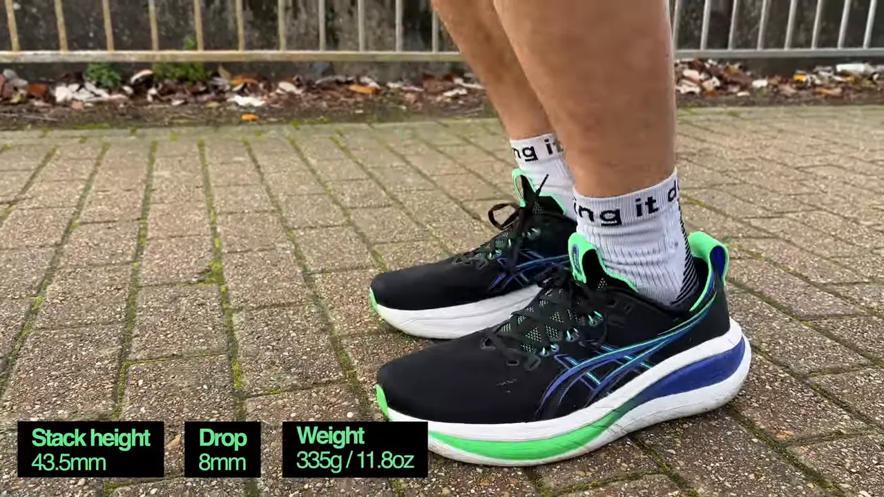 Asics Gel Nimbus 28 on feet with on-screen specs showing stack height 43.5mm, drop 8mm and weight 335g
