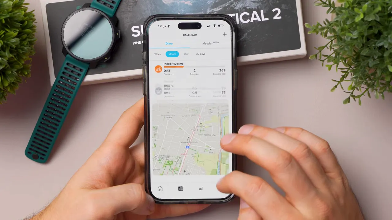 Smartphone showing Suunto app map with a recorded route and finger interacting