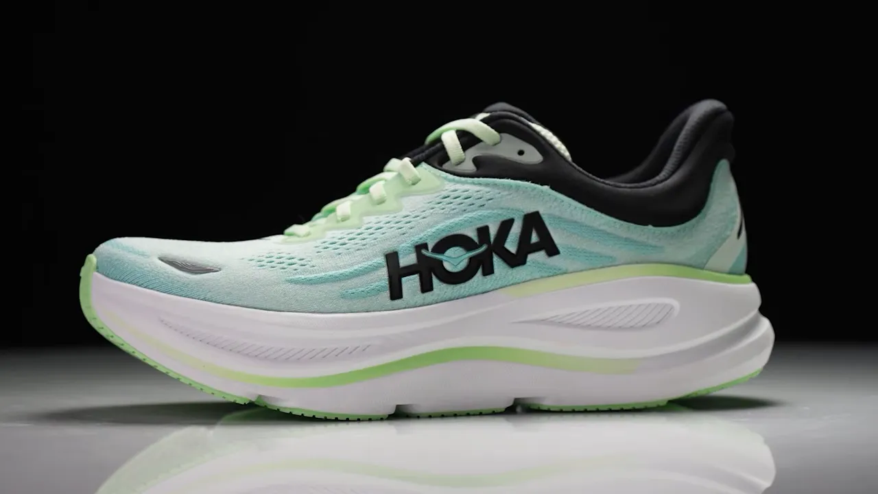 Side profile of Hoka Bondi 9 in mint and white showing thick midsole and HOKA logo