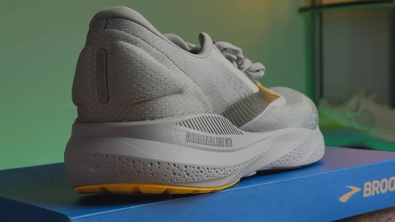 Rear three-quarter view of the Brooks Adrenaline GTS on its box showing heel, midsole and 'ADRENALINE GTS' text