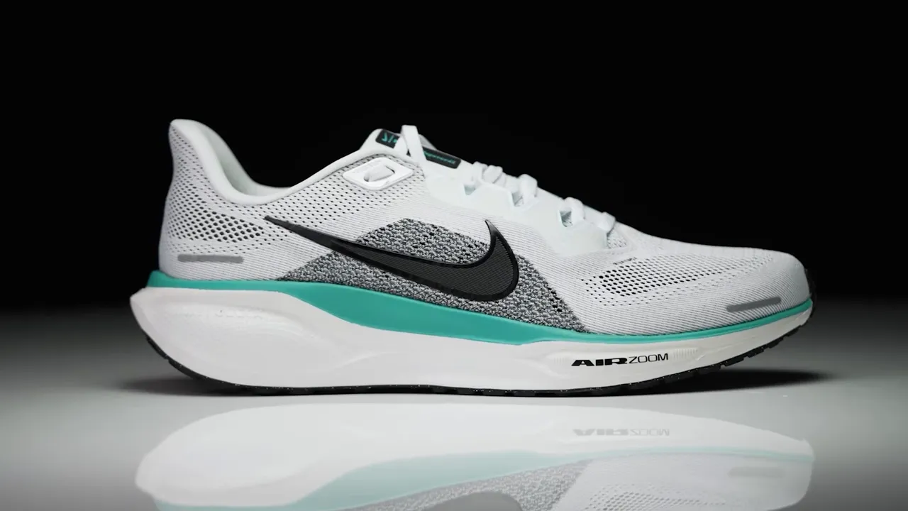 Side profile of a Nike Pegasus shoe in white and teal showing Air Zoom midsole