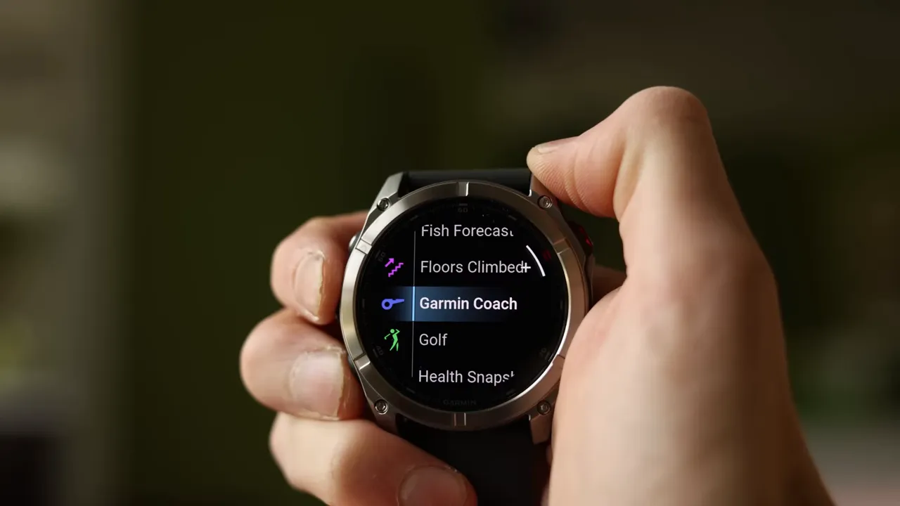 Garmin Fenix 8 Pro menu with Garmin Coach highlighted, held in hand