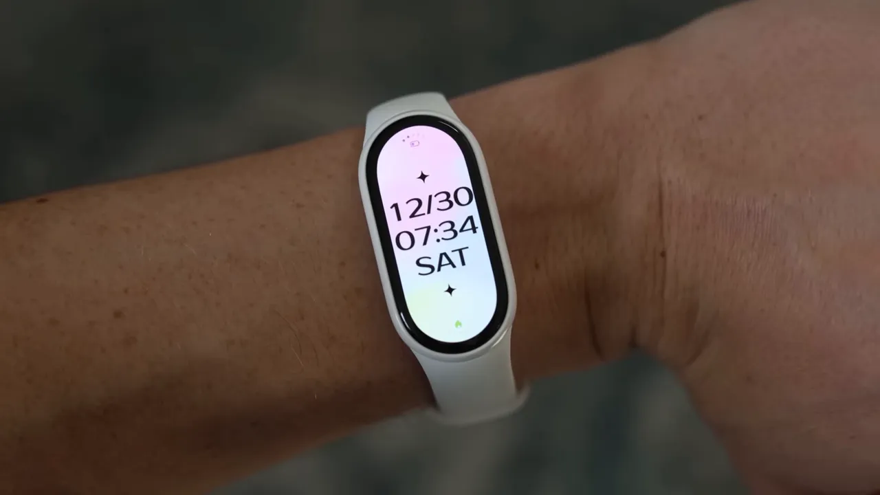 Xiaomi Smart Band 10 worn on a wrist showing a tall vertical date and time display
