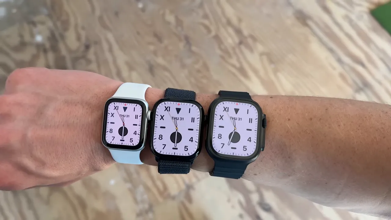 Three Apple Watch models worn on one wrist, with the larger Apple Watch Ultra on the right