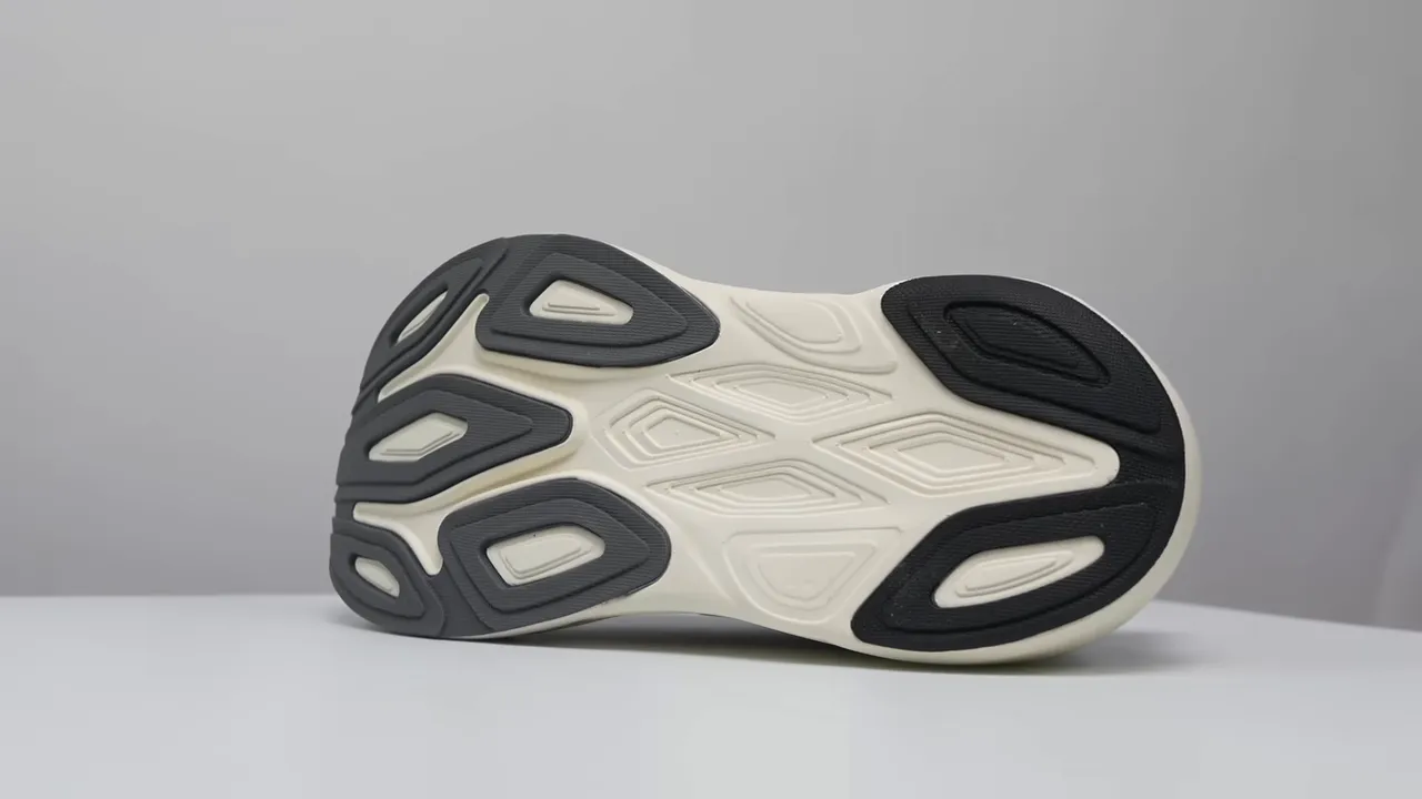 flat shot of New Balance More v6 outsole showing rubber coverage and exposed foam