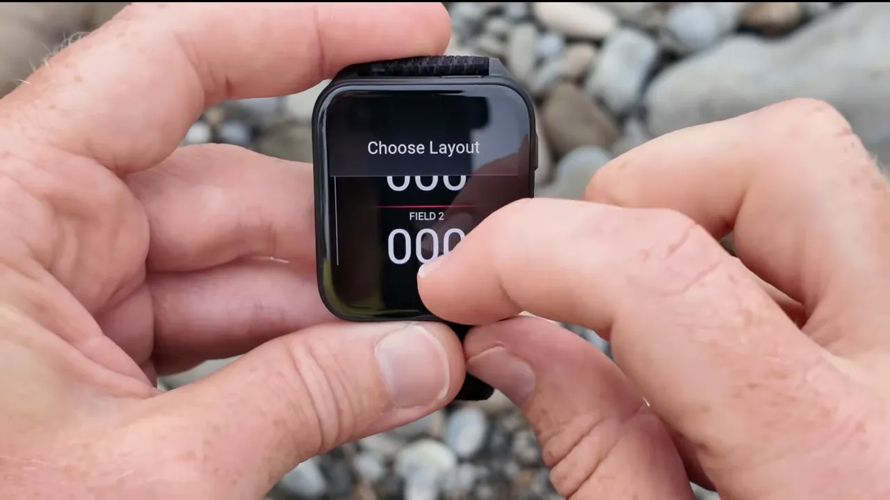 Garmin Venu X1 screen showing 'Choose Layout' menu with numeric field placeholders and a finger selecting a layout