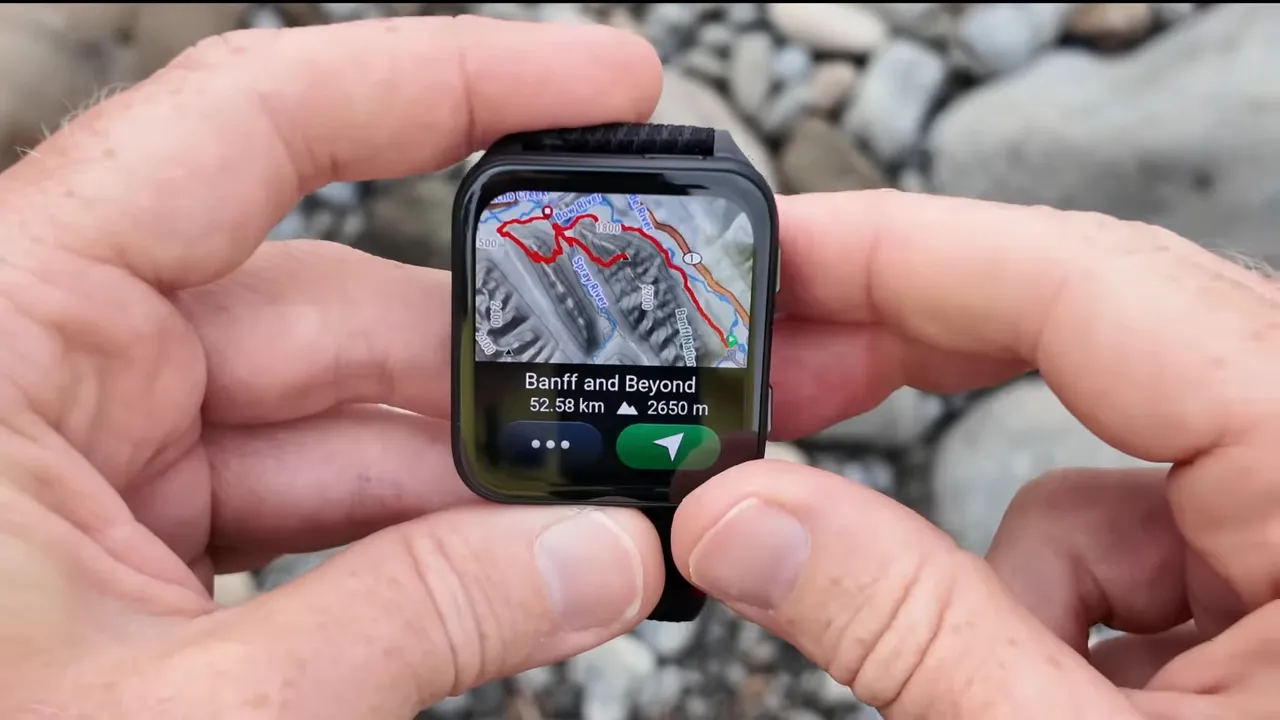 Garmin Venu X1 displaying a detailed satellite-style map with a red route overlay and route stats (Banff and Beyond, distance and elevation)