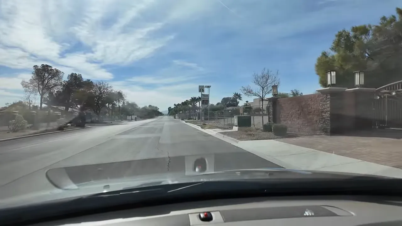 View down a quiet Las Vegas road in Section 10 with large lots and low fencing