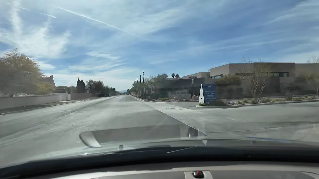 Street view in Las Vegas Section 10 near a modern luxury community sign for Prado/Blue Heron area