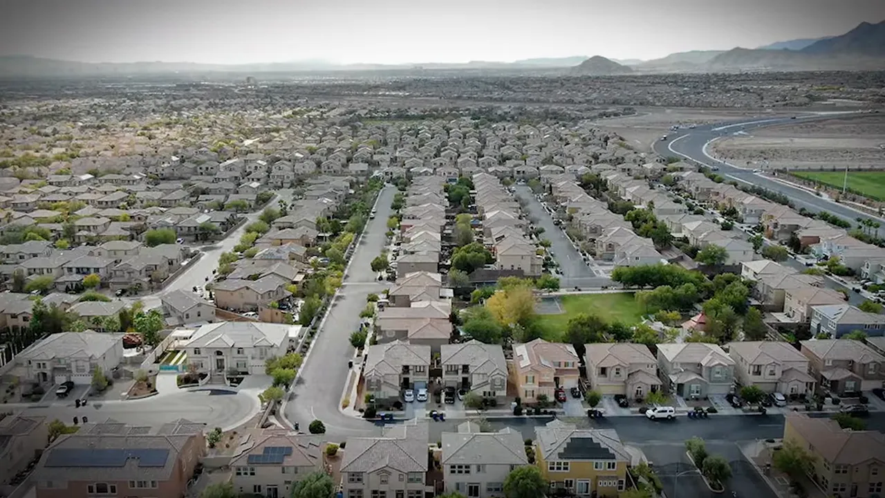Aerial view of a new‑construction suburban neighborhood with homes, streets, and a small park near Las Vegas