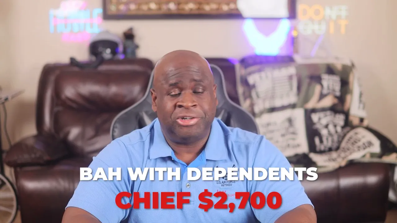 Presenter with on-screen text overlay reading 'BAH WITH DEPENDENTS CHIEF $2,700' in a home setting