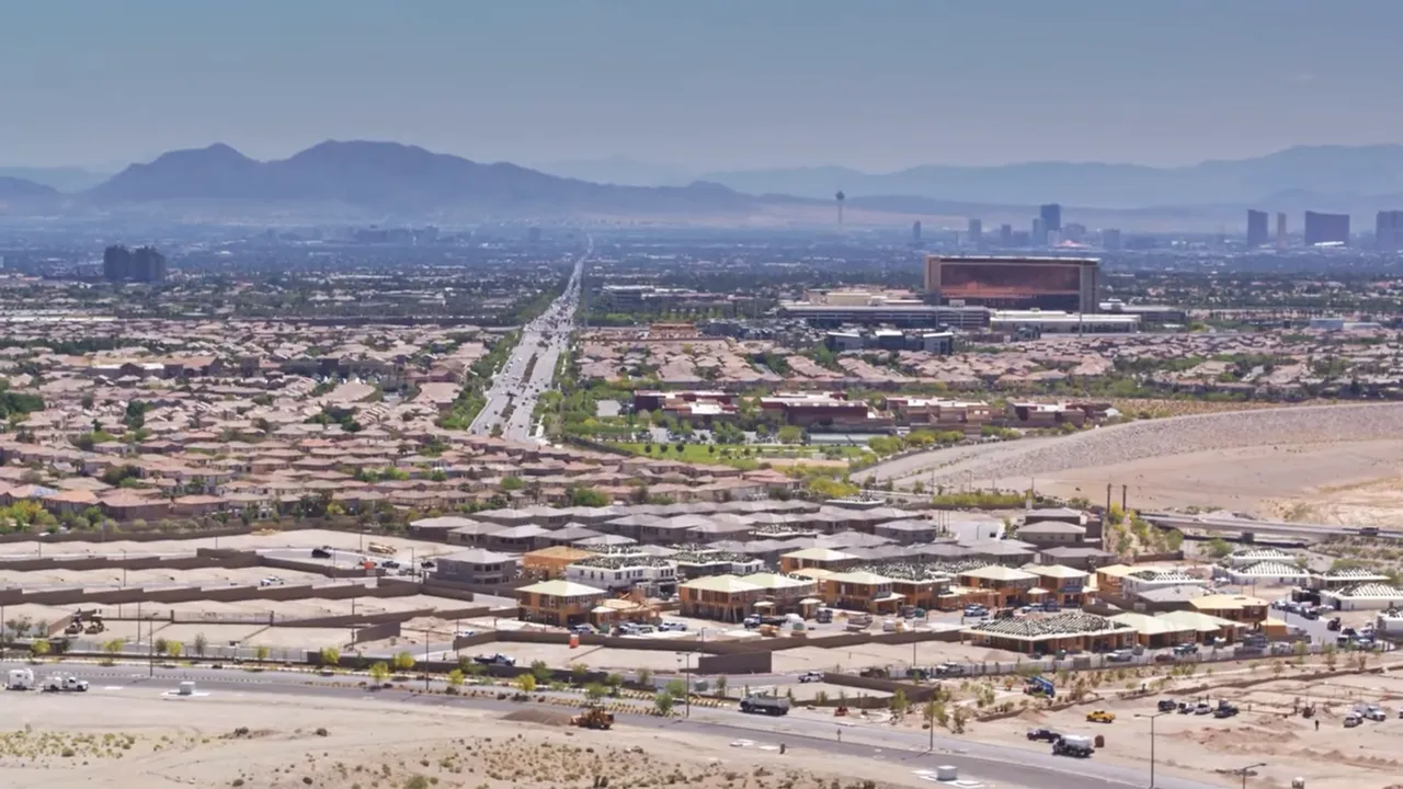 Wide daytime panorama of Las Vegas suburbs with the Strip skyline visible in the distance