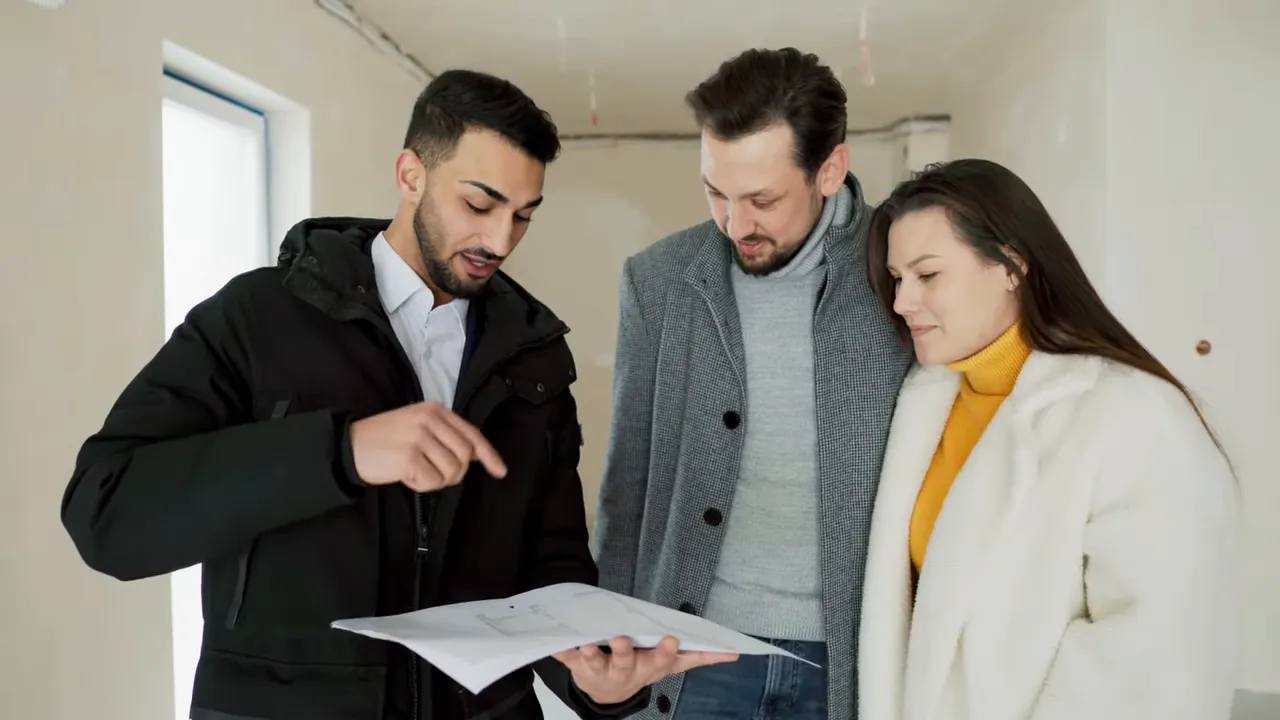 Agent walking clients through a model home and discussing floorplans
