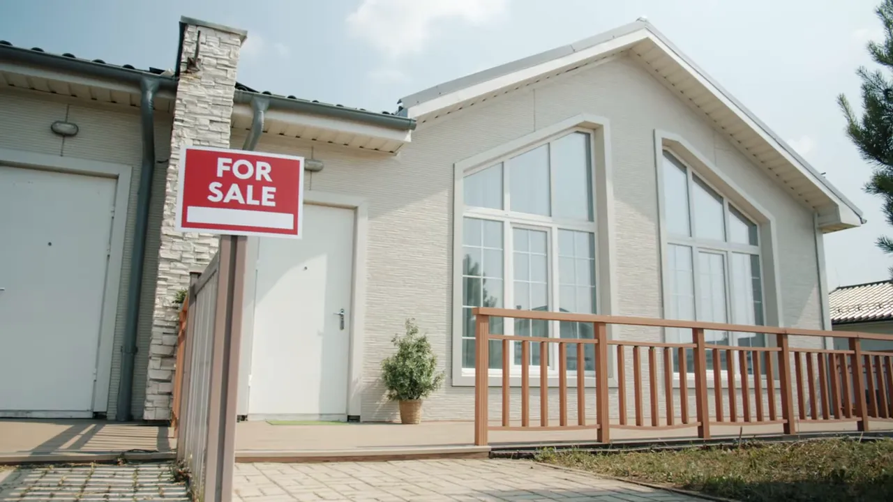Wide exterior view of a house with a prominent red 'For Sale' sign in front.