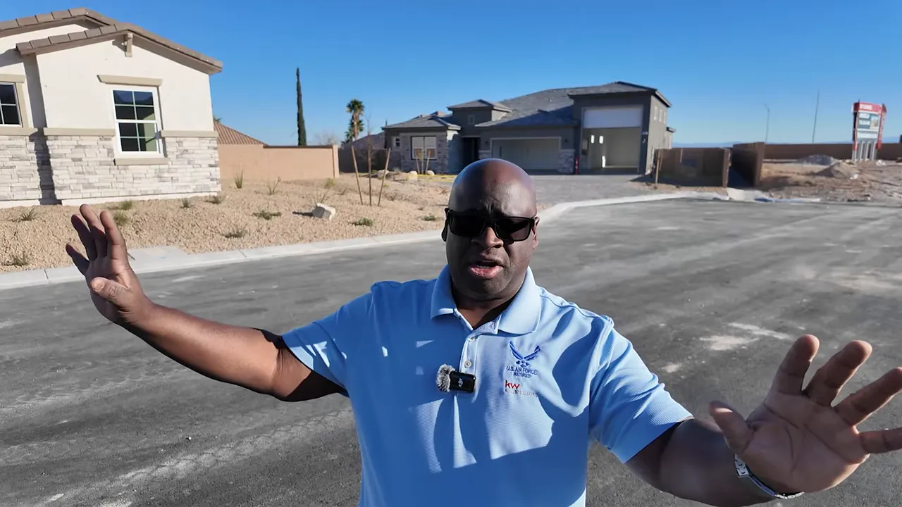 Agent presenting on a driveway at a new build site while explaining upfront costs