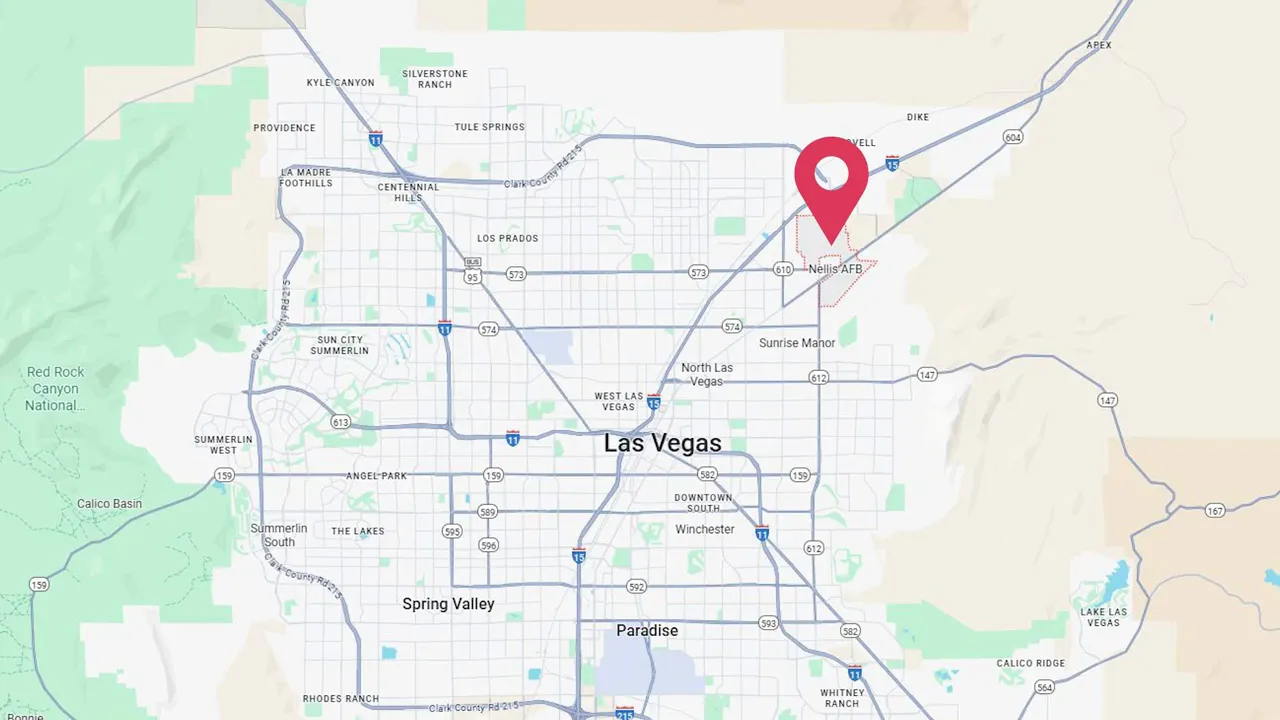 Nellis AFB aircraft flying over base with runway in view