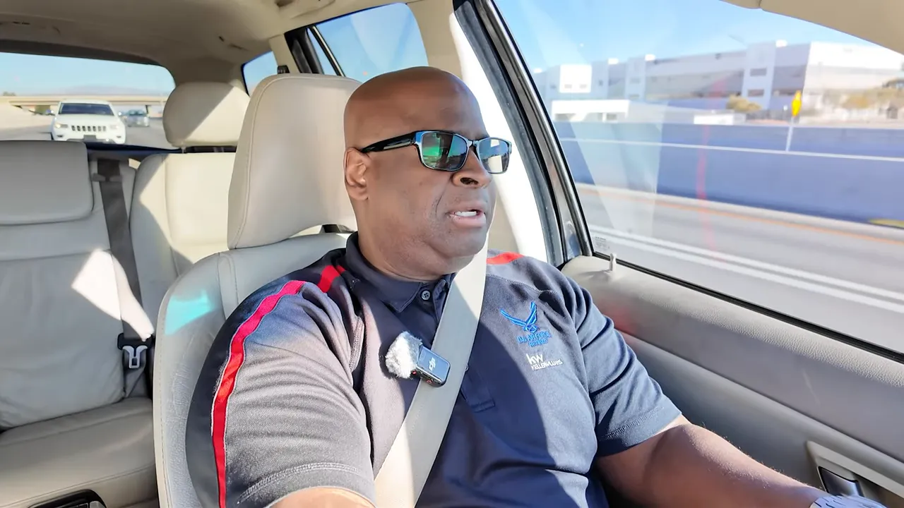 Clear high-resolution screenshot of presenter driving and speaking in a car