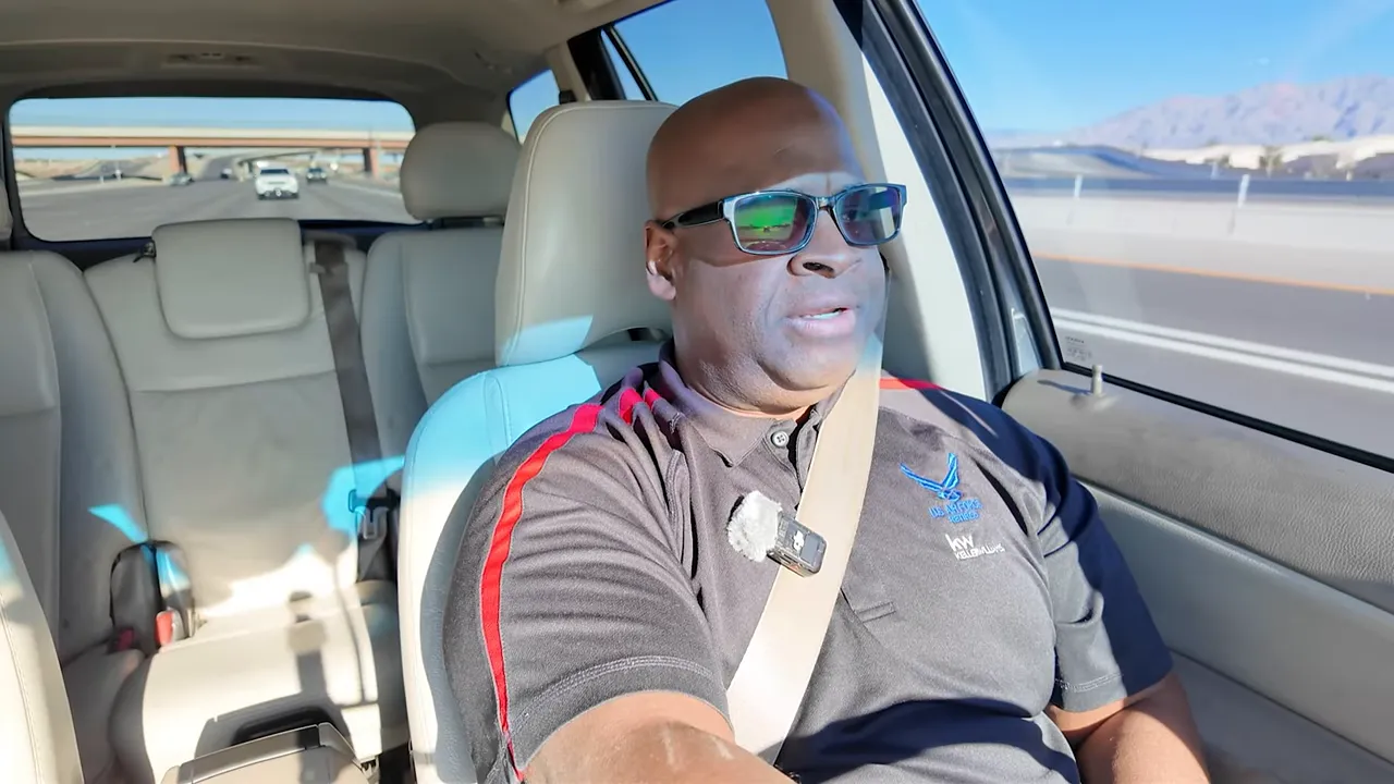 Clear high-resolution screenshot of presenter driving and speaking in a car